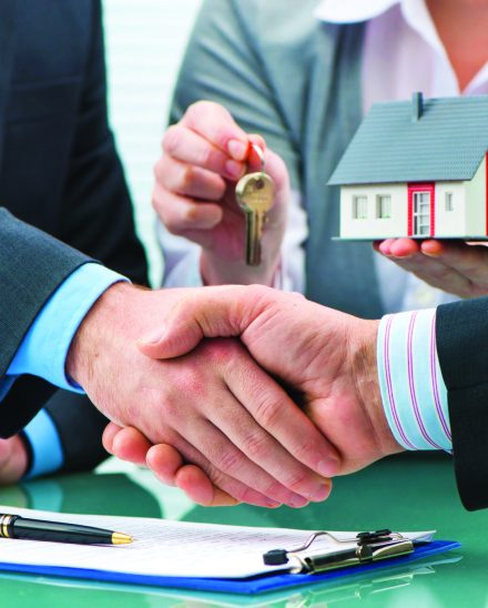52325961 - estate agent shaking hands with customer after contract signature